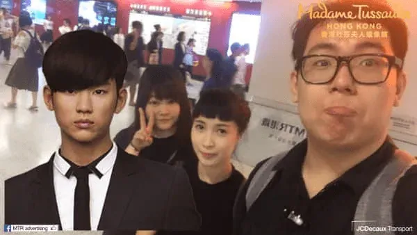 Passengers taking an augmented reality selfie with a celebrity at an MTR station checkpoint